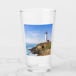 Lighthouse on hill blue sky white house ocean glass