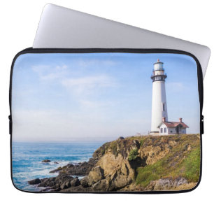 Lighthouse on hill blue sky white house ocean laptop sleeve