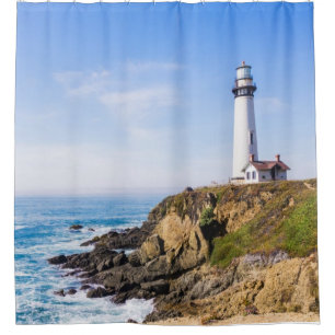Lighthouse on hill blue sky white house ocean shower curtain