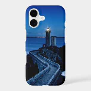 Lighthouse on wall in ocean at night