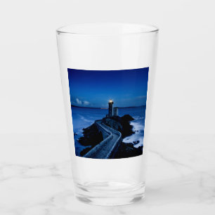 Lighthouse on wall in ocean at night glass