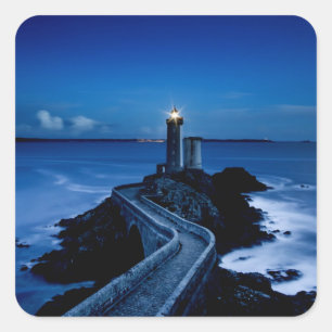 Lighthouse on wall in ocean at night square sticker