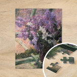 Lilacs in a Window | Mary Cassatt Jigsaw Puzzle<br><div class="desc">Lilacs in a Window (1880) by Mary Cassatt is a delicate still-life painting that showcases a vase filled with vibrant lilacs placed near a window. The artwork captures the beauty of fresh blooms and the gentle light filtering through the glass, evoking a sense of tranquility. Cassatt’s careful attention to detail...</div>