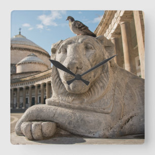 Lion statue in front of historic church square wall clock