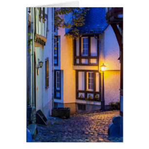 Lit Street Lamp on Cobbled Street