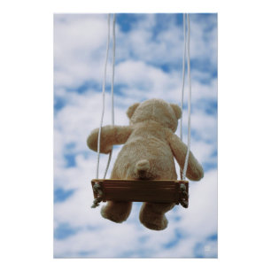 Little bear on a swing with a cloudy blue sky. poster