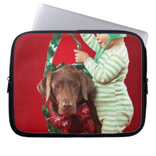 Little boy decorating a dog laptop sleeve
