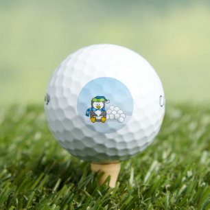 Little penguin sitting with snowballs golf balls