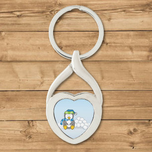 Little penguin sitting with snowballs key ring