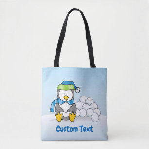 Little penguin sitting with snowballs tote bag