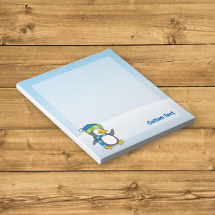 Little penguin walking on snow notepad