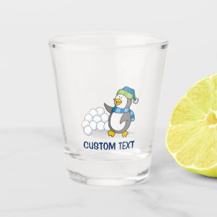 Little penguin with snow balls waving shot glass