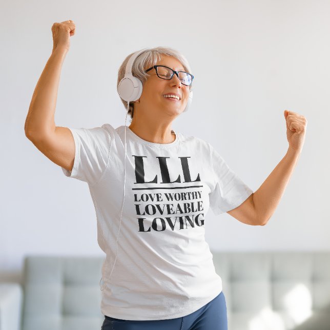 LLL- Love Worthy, Loveable, Loving T-Shirt (Older woman dances in a "LLL: Love Worthy, Loveable, Loving" white t-shirt.)