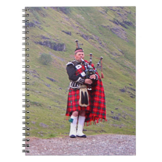 Lone Scottish bagpiper, Highlands, Scotland Notebook