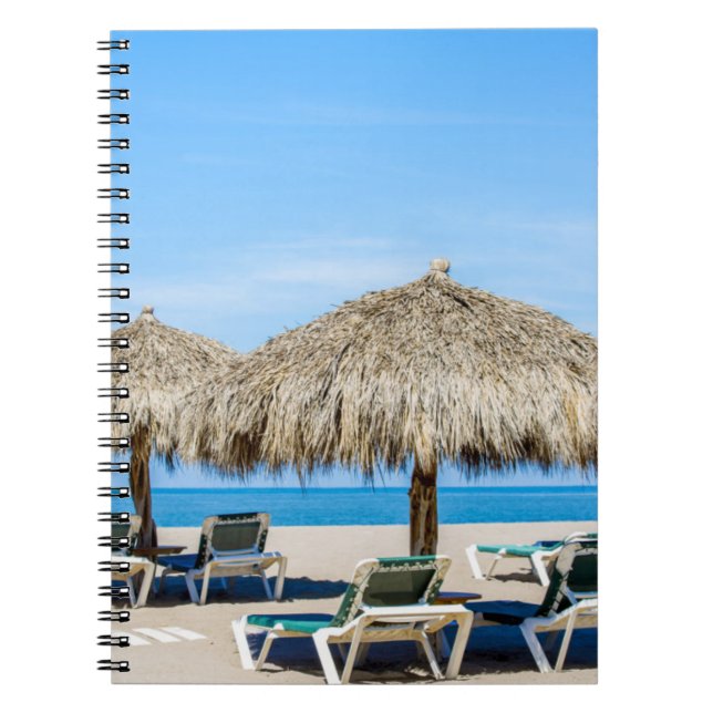 Lounge Chairs And Thatch Umbrellas On Beach Notebook (Front)