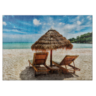 Lounge chairs on beach throw pillow cutting board