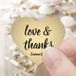Love and Thanks Black and Gold Faux Foil Thank You Heart Sticker<br><div class="desc">Add an elegant personalised finishing touch to thank you notes, party favours, and decorations with these chic calligraphy heart shaped stickers / envelope seals. Design features gold faux metallic foil, stylish script love and thanks, and a name. All text on these versatile labels is simple to customise, and can be...</div>