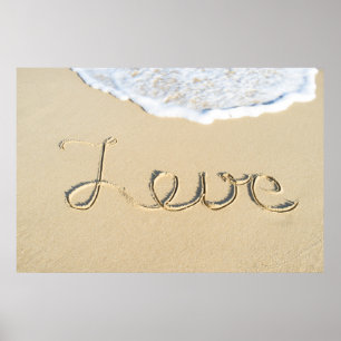 Love carved sign on the beach sand