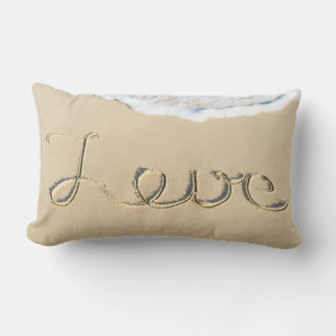Love carved sign on the beach sand lumbar cushion
