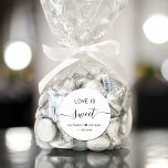 Love Is Sweet Wedding Favour Classic Round Sticker<br><div class="desc">Chic white sticker for your wedding reception dessert and candy favours featuring "Love Is Sweet" in simple modern typography and an elegant script with swashes,  your first names joined together by a heart and your wedding date.</div>