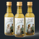 Love & Thanks Blue Wildflowers Wedding Photo Mini Wine Label<br><div class="desc">Thank your wedding guests with these beautiful personalised mini wine bottle labels. The rustic boho chic design features a spray of country wildflowers in shades of dusty blue and sage green with photo is displayed in an arch shaped frame. The title is printed in elegant script lettering with swashes and...</div>