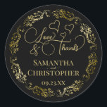 Love & Thanks Elegant Black & Gold Wedding Classic Round Sticker<br><div class="desc">These beautiful black and gold stickers are designed to use as wedding favour tags, or as envelope seals for your wedding thank you cards. The elegant design features an ornate lacy golden border with fancy script lettering reading "Love & Thanks!" There are romantic hearts scattered about with room for the...</div>
