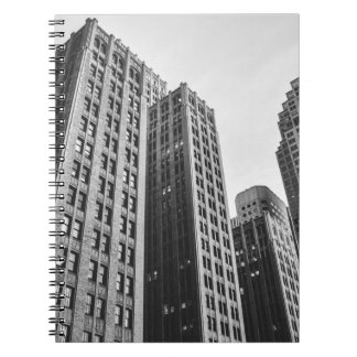 LOW ANGLE GRAYSCALE PHOTOGRAPHY OF HIGH-RISE BUILD NOTEBOOK