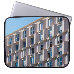 LOW ANGLE PHOTO OF GRAY CONCRETE BUILDING LAPTOP SLEEVE