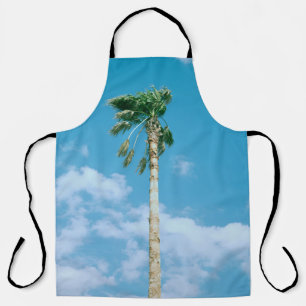 Low-angle photo of palm trees under blue sky apron