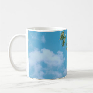 Low-angle photo of palm trees under blue sky coffee mug