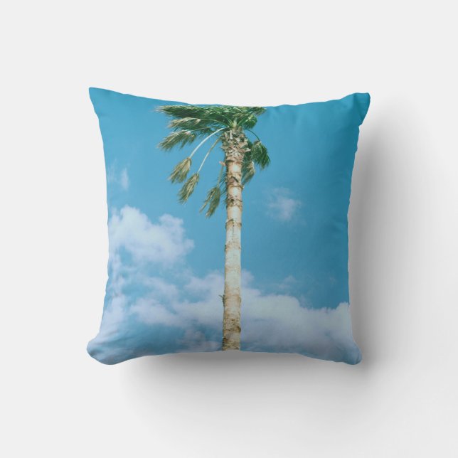 Low-angle photo of palm trees under blue sky cushion (Front)