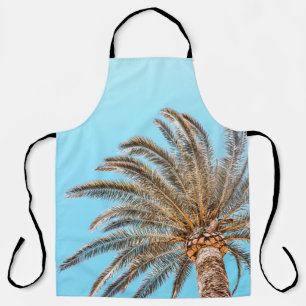 Low-angle photography of a green palm tree under a apron