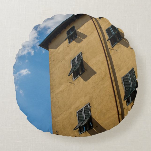 LOW ANGLE PHOTOGRAPHY OF BROWN LOUVER WINDOW ROUND CUSHION (Front)