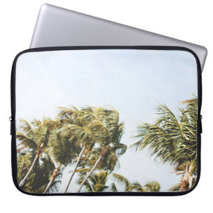 LOW-ANGLE PHOTOGRAPHY OF GREEN COCONUT TREES UNDER LAPTOP SLEEVE