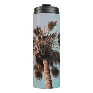 Low-angle photography of palm plant thermal tumbler