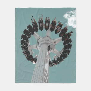 Low-angle photography of people riding a drop-down fleece blanket