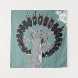 Low-angle photography of people riding a drop-down tapestry