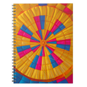 Low angle photography of yellow, pink, and black h notebook