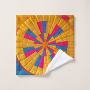 Low angle photography of yellow, pink, and black h wash cloth
