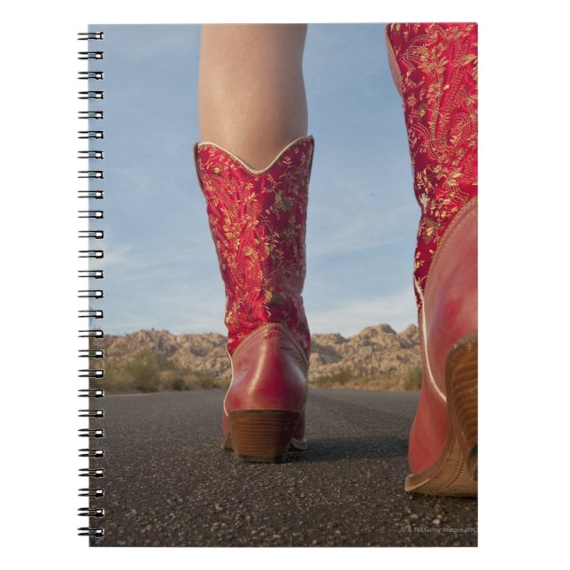 Low-angle view of woman wearing cowboy boots notebook (Front)