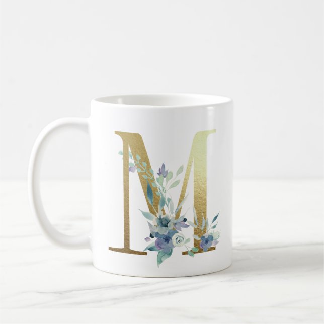 M,  golden initial with blue floral foliage coffee mug (Left)