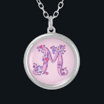 M monogram decorative letter necklace<br><div class="desc">Pretty letter M monogram pendant. Whimsical letter drawing of the capital initial letter M,  ideal for gifting girls with a name that begins with M. Background colour can be changed if required,  currently light pink. © Original drawing and design by Sarah Trett www.sarahtrett.com for www.mylittleeden.com</div>