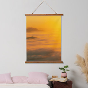 Magical autumn sunrise above clouds hanging tapestry