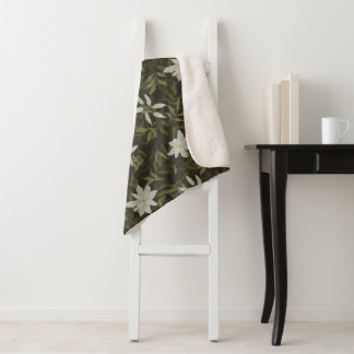 Magnolia and green leaves on black sherpa blanket