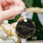 Maid of Honour Wedding Gift Gold Frills on Black Key Ring<br><div class="desc">These keychains are designed to give as favours to the Maid of Honour in your wedding party. They feature a simple yet elegant design with a classic black background, gold text, and a lacy golden faux foil floral border. The text reads "Maid of Honour" with space for her name, the...</div>