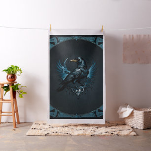 Majestic black raven sitting on an ornate, fabric