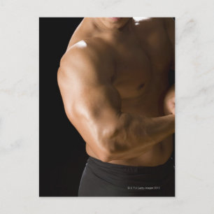 Male bodybuilder flexing muscles, front view, 2 postcard