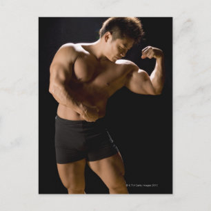 Male bodybuilder flexing muscles, front view, postcard