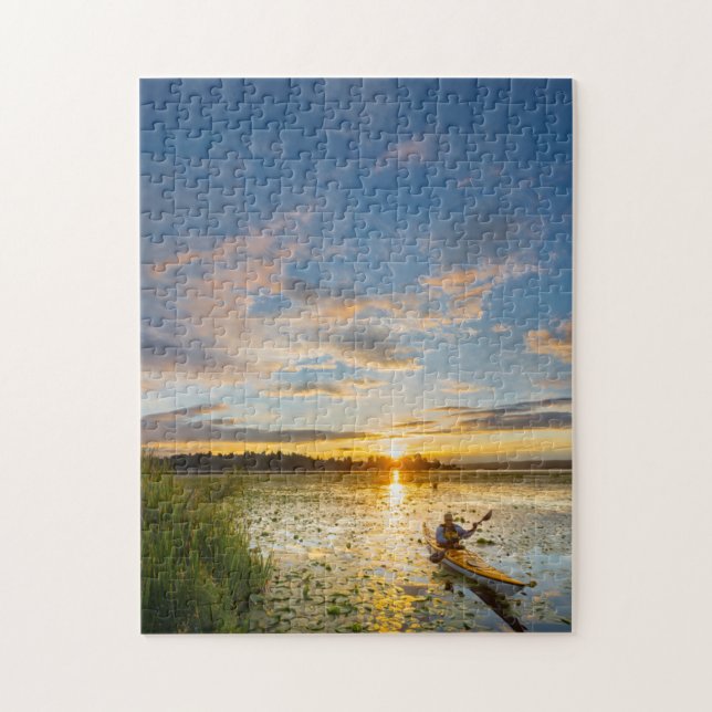Male kayaker paddling sea kayak on still water jigsaw puzzle (Vertical)