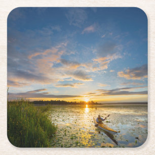 Male kayaker paddling sea kayak on still water square paper coaster